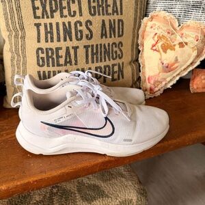 Nike Light Cream Sneakers with Black Swoosh and Pink Accent
